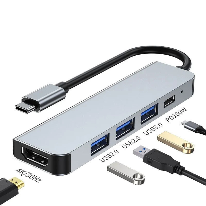 Compact silver USB-C expansion dock for laptops with multiple ports including HDMI and USB-A.