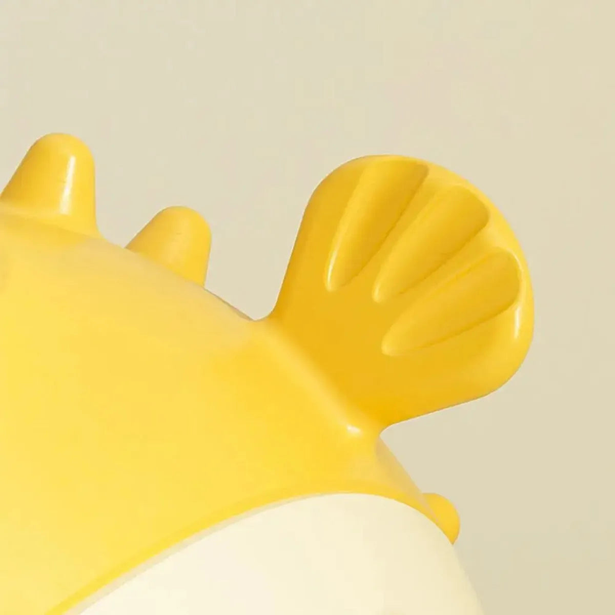 Yellow fish-shaped dog chew toy with textured surface and squeaker, measuring 20cm long