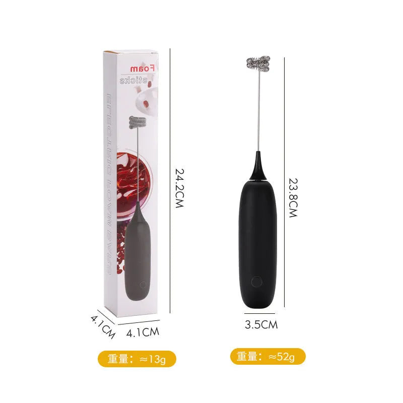 Hand-held milk frother with stainless steel whisk in modern black design creating microfoam in coffee cup