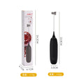 Hand-held milk frother with stainless steel whisk in modern black design creating microfoam in coffee cup