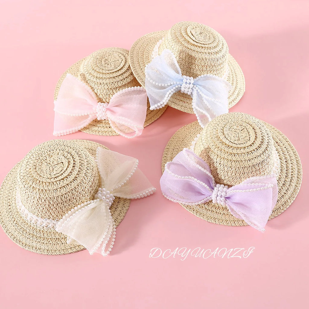Pet cat wearing a straw hat with pearl bow in blue, sizes 13cm and 15cm, made from Lafite leaves.