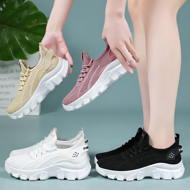 Women's Flyknit sneakers in beige with flat heel, round toe, and lace-up front, showing breathable upper and PVC sole