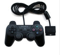 PS2 wired USB game controller in bare metal finish on a grey background