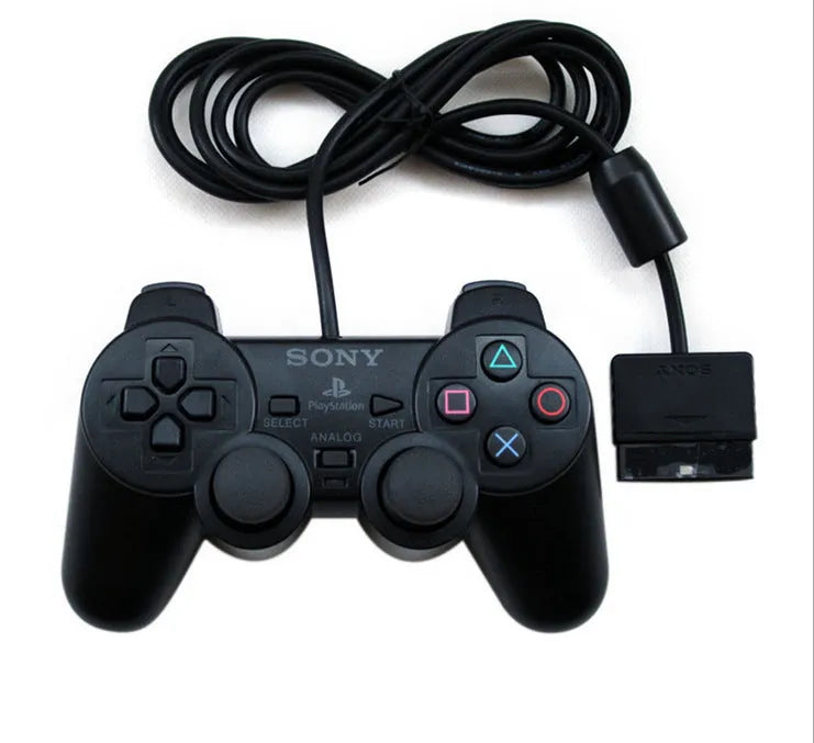 PS2 wired USB game controller in bare metal finish on a grey background
