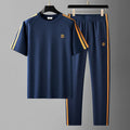 Men's blue short sleeve suit with top and trousers, made from polyester fibre for sweat absorption and breathability.