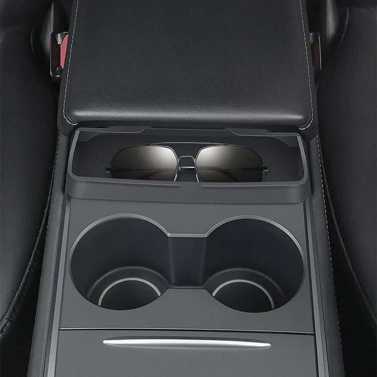 Black silicone sunglasses case installed inside a Tesla Model 3 or Y centre console armrest.