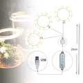 USB-powered LED grow light with transparent housing showing yellow LEDs, attached to 25cm acrylic stick for plant illumination