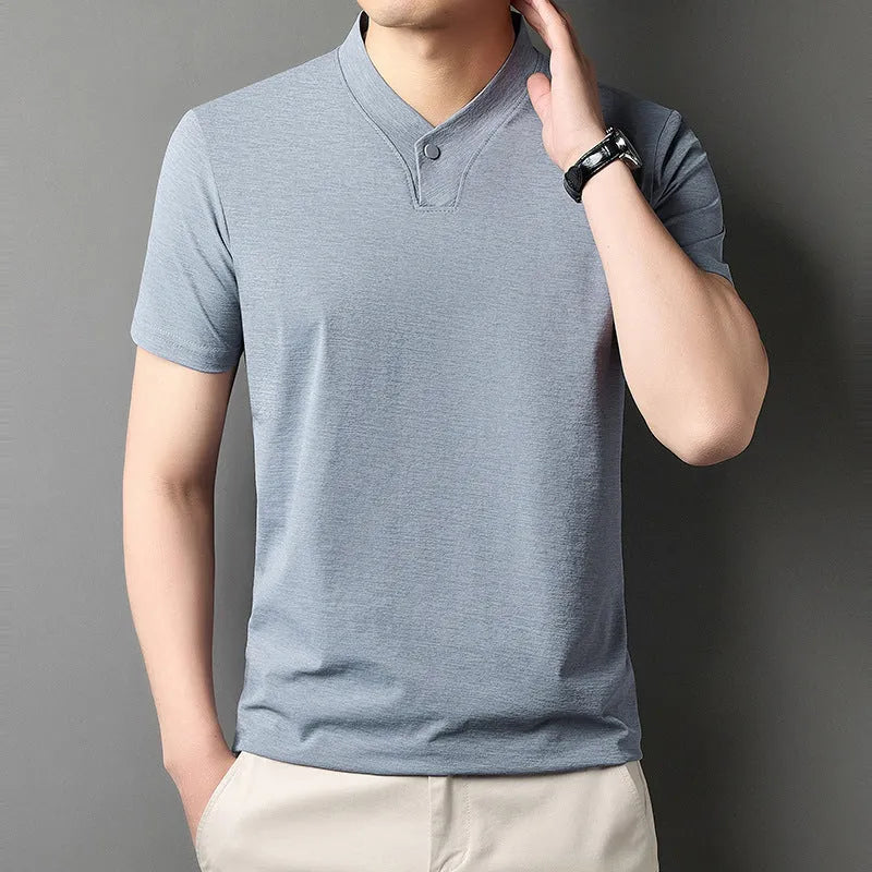 Young man wearing a short sleeve zip collar T-shirt in a casual setting.