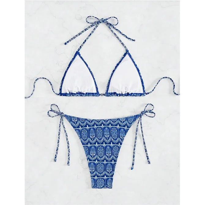 Women's green bandage-style split bikini swimsuit with stitching detail on a mannequin.