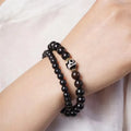 Solid ebony wood Tibetan bead bracelet with two circular 8mm beads on wrist
