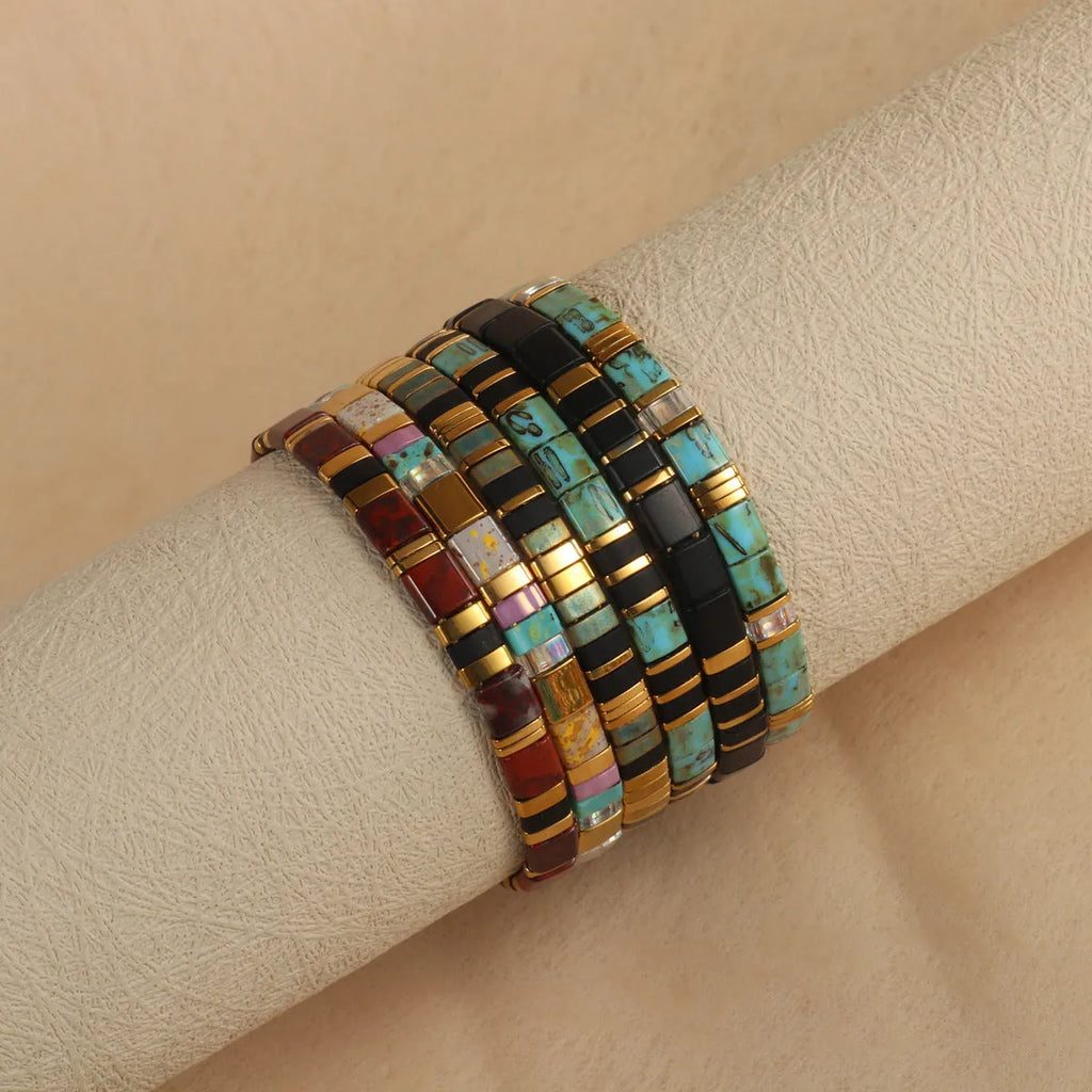Geometric glass beads bracelet in five colour options showing 8mm beads and secure clasp on wrist