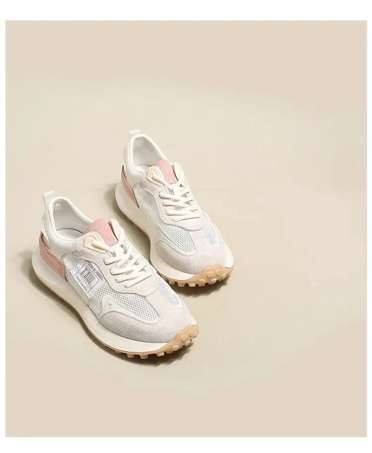 Women's grey and pink low-top retro sneaker with round toe and flat rubber sole.