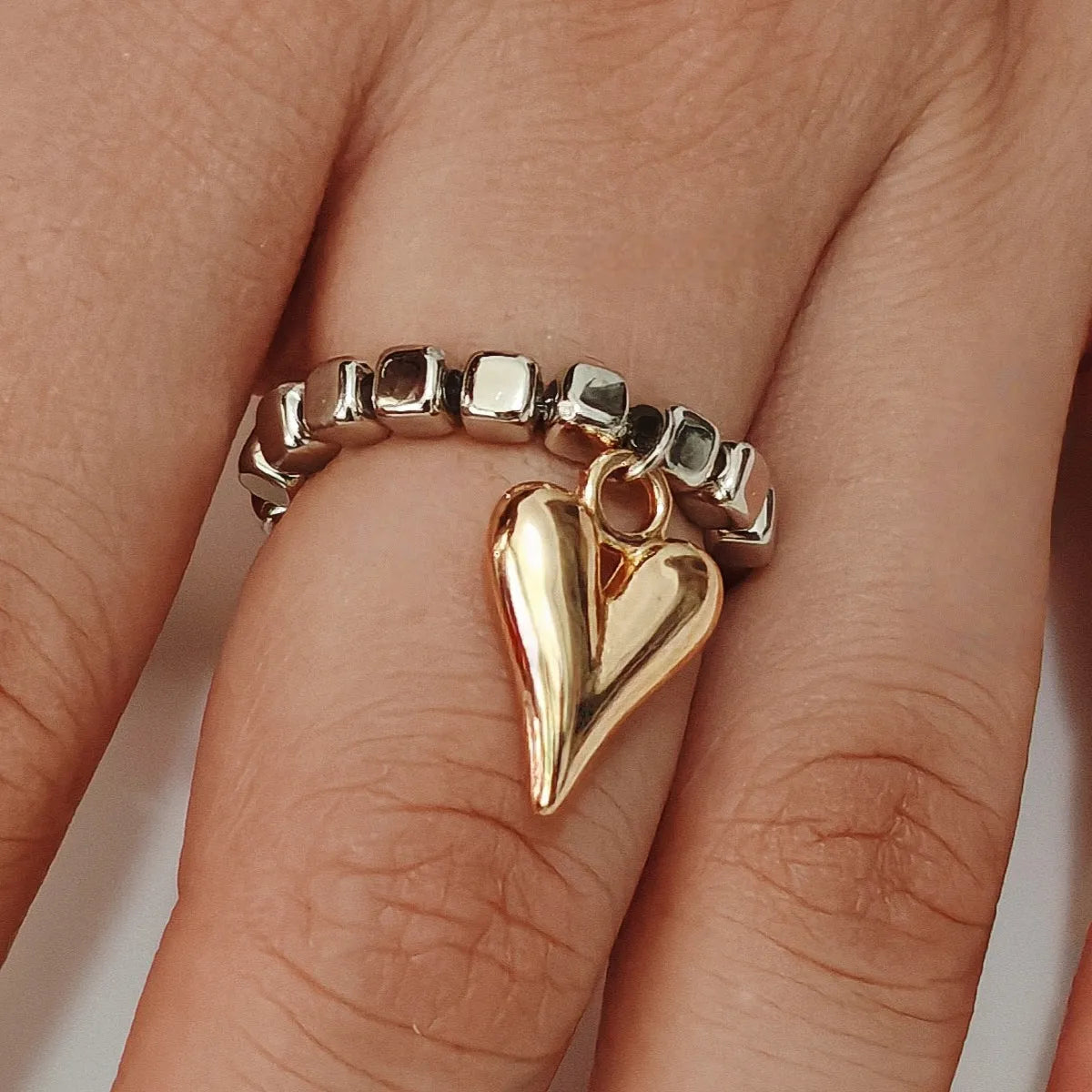 Handmade beaded elastic love ring with geometric heart design in gold and white colour options