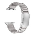 Black titanium alloy Apple Watch replacement strap with folding buckle on a wrist