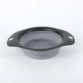 Black and green silicone pet bowls shown folded flat and unfolded ready for use.