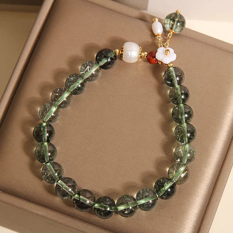 Green phantom quartz crystal bracelet with small bells of Ireland design and shell flower accents