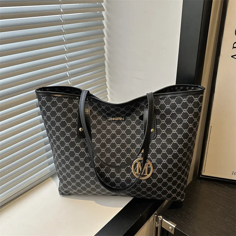 PU street style shoulder bag in black showing 42cm width and sewing thread detailing with polyester lining