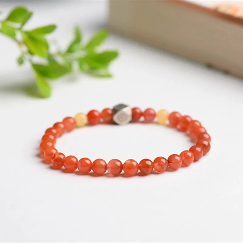 Natural Nanhong Agate zodiac bracelet with a beeswax bead, showing constellation design.