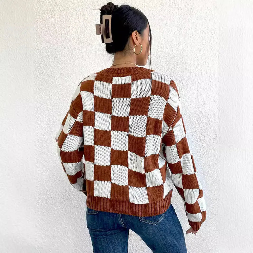 Dark brown plaid pattern pullover sweater with long sleeves and round neck, laid flat showing full design