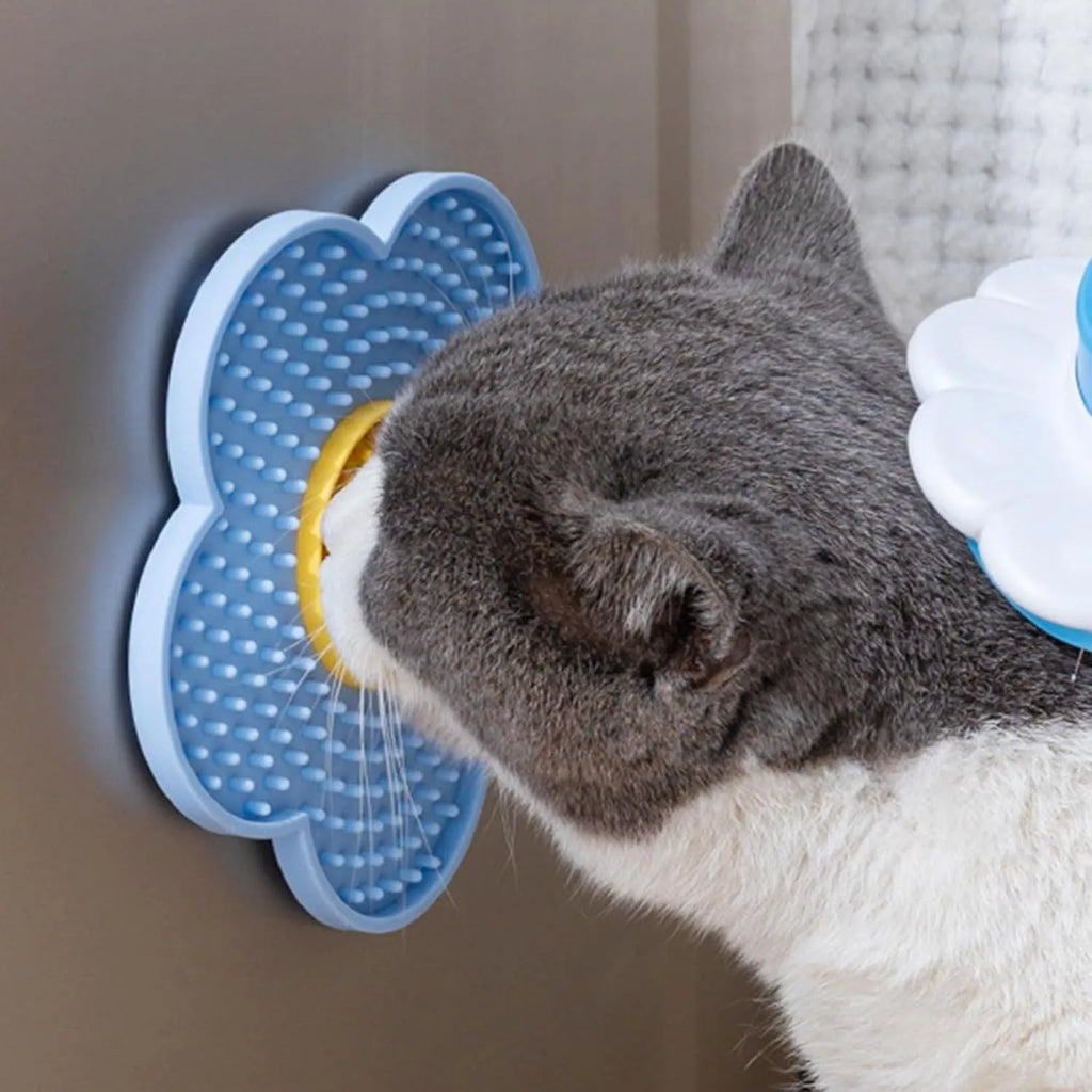 Flower-shaped silicone slow feeder licking mat for dogs and cats with suction cups on a smooth surface.