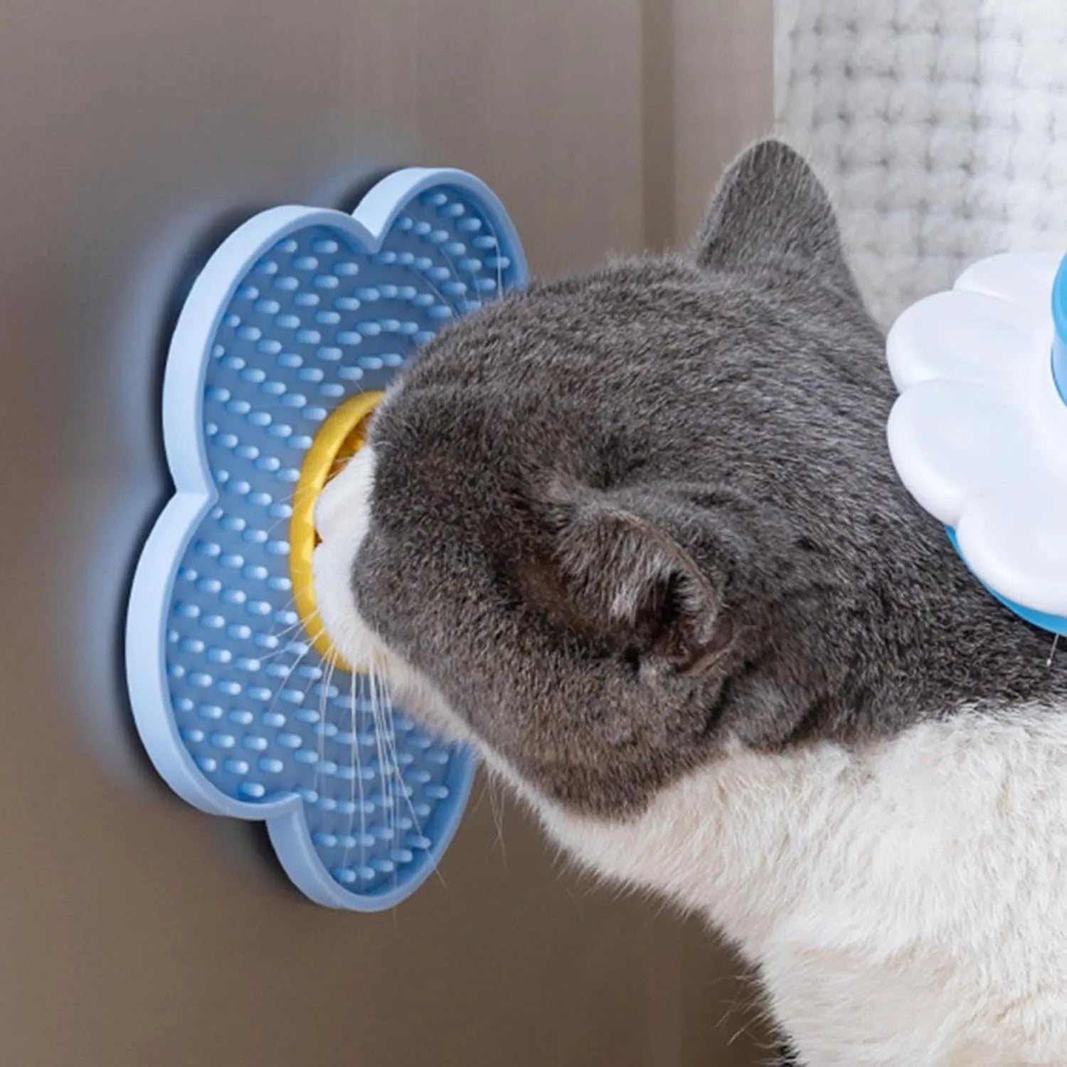 Flower-shaped silicone slow feeder licking mat for dogs and cats with suction cups on a smooth surface.