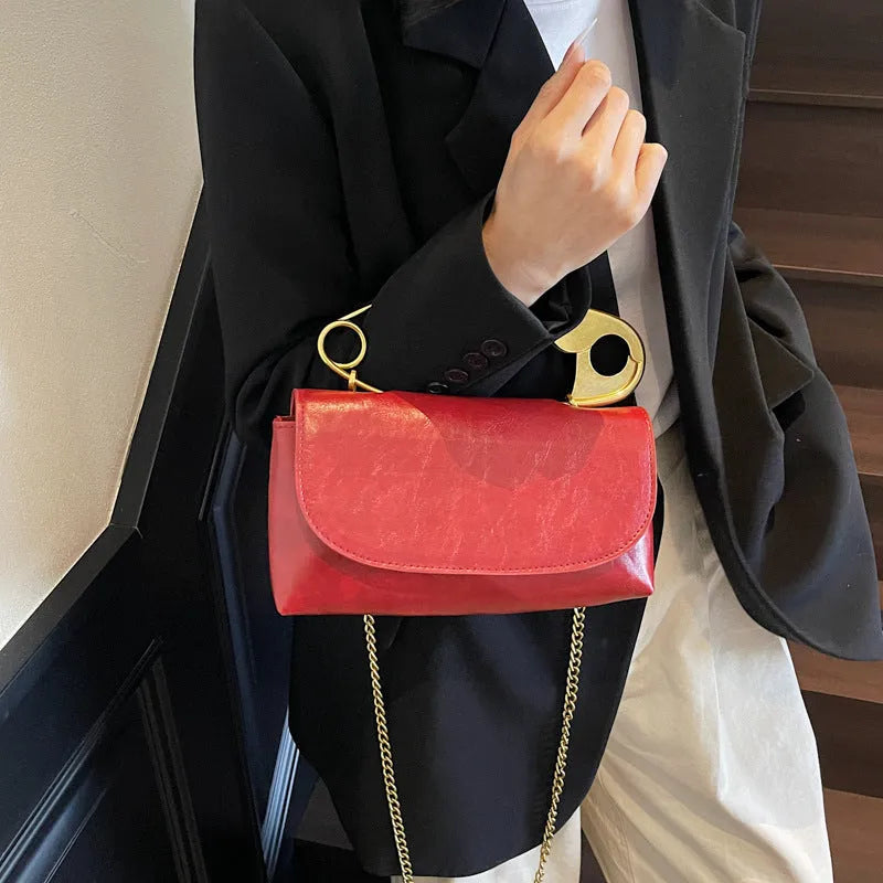 Black street trend shoulder handbag with sandwich pockets and visible sewing thread details.