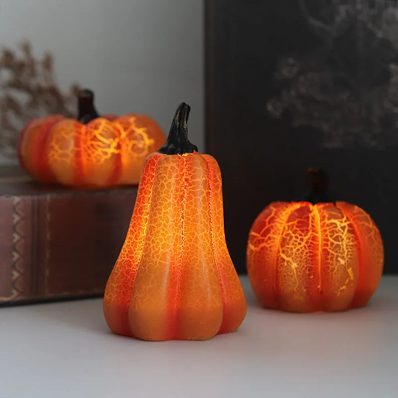 Set of three resin Halloween pumpkin lanterns with LED candle lights in short, medium, and long sizes.