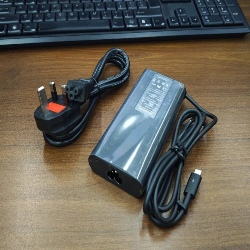 Black 65W USB Type-C laptop power adapter with international travel plug set