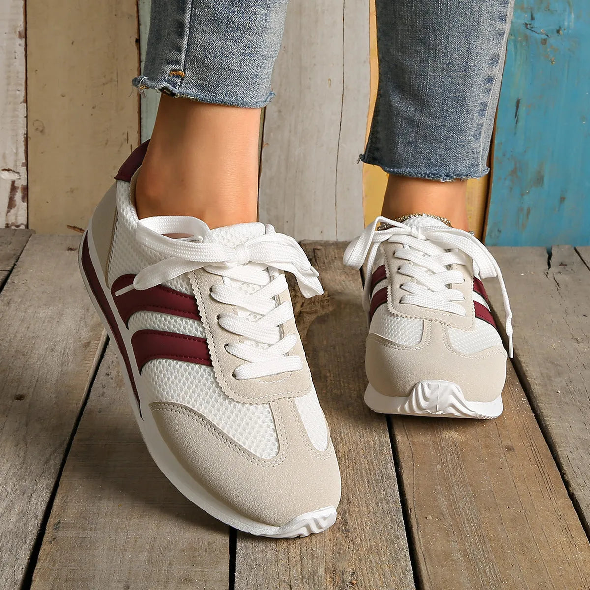 Wine red Cortez Retro low-top sneakers with cross-strap detail on synthetic leather upper.