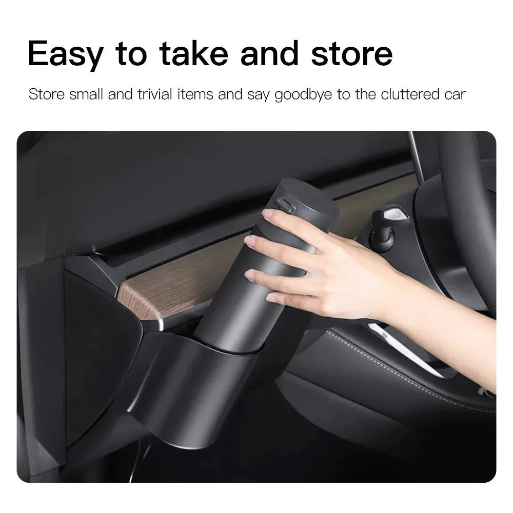 A plastic water cup holder designed for the dashboard of a left-hand drive Tesla Model 3 or Model Y.