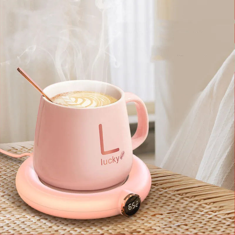 White USB cup warmer pad on desk with LED display showing temperature setting and mug on top