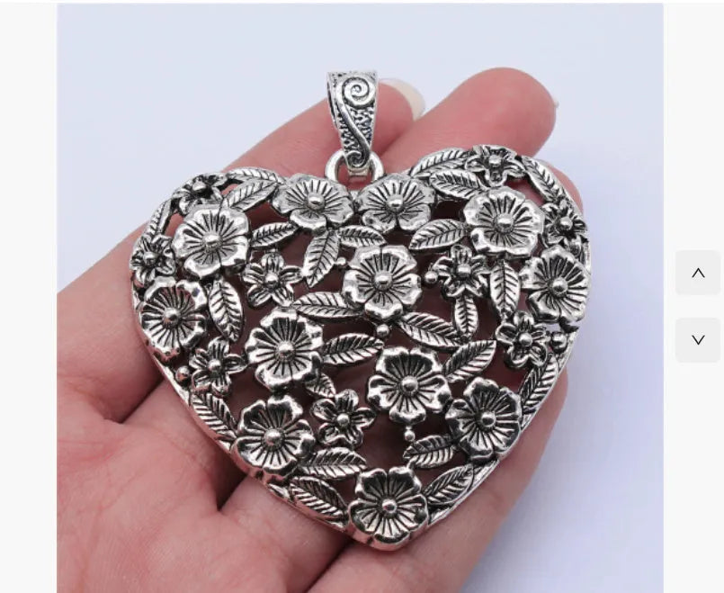Ancient silver hollow flower alloy pendant measuring 67mm by 58mm