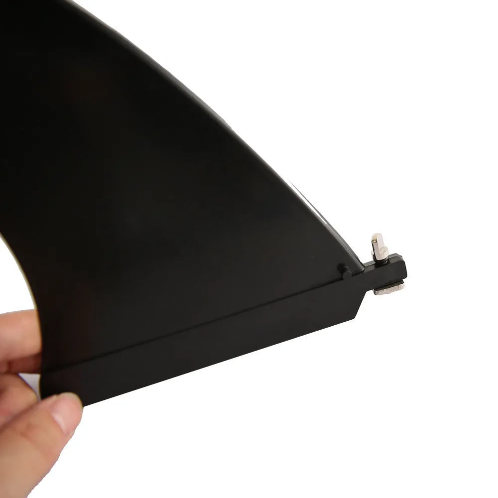 SUP paddle with detachable fish fins showing screw attachment mechanism and plastic construction