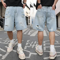Light blue ripped denim shorts with distressed details and straight leg cut in hip hop streetwear style