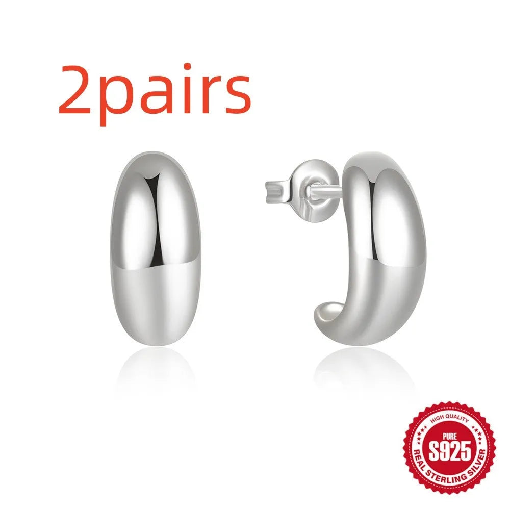 C-shaped sterling silver earring with electroplated gold finish on a stud backing