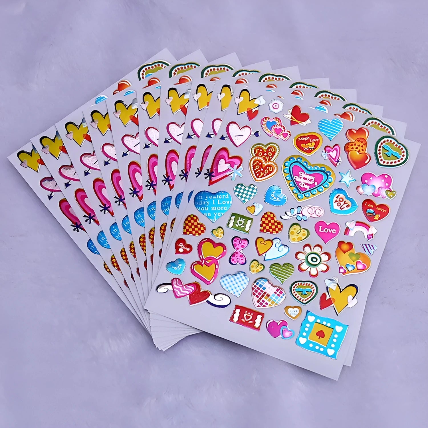100-piece pack of gold-detailed cartoon heart waterproof reward stickers laid out.