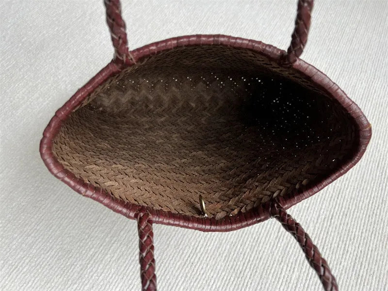 Brown woven leather tote bag with three-dimensional pocket, showing 27x30x6cm dimensions and handmade construction