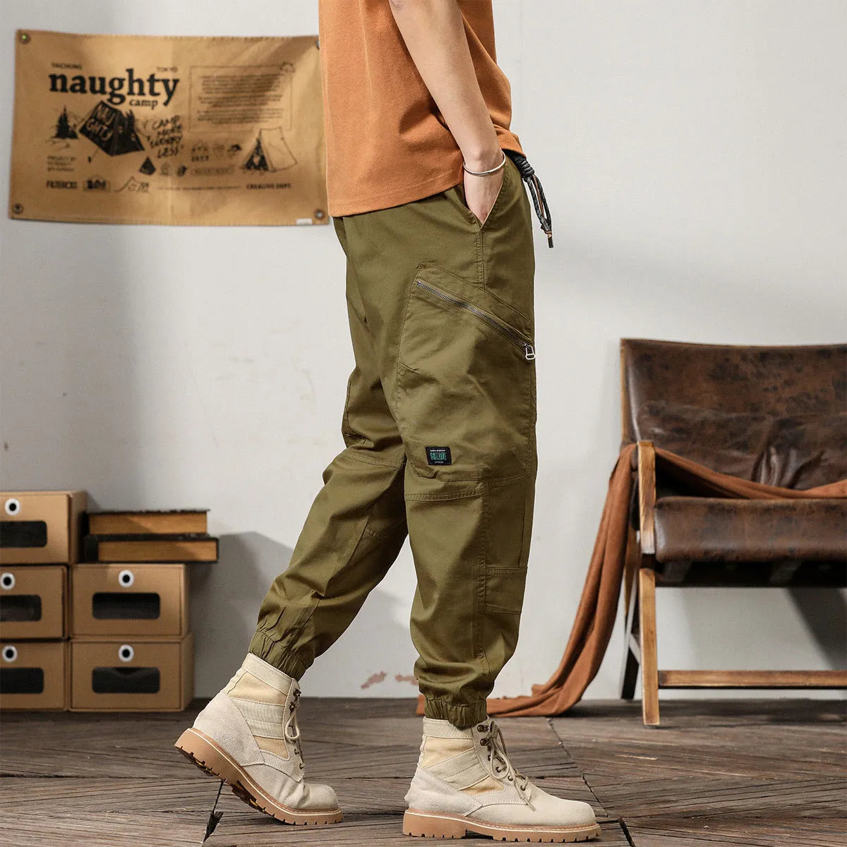 Men's khaki harem pants with tapered legs and ankle bands, made from non-iron cotton fabric.