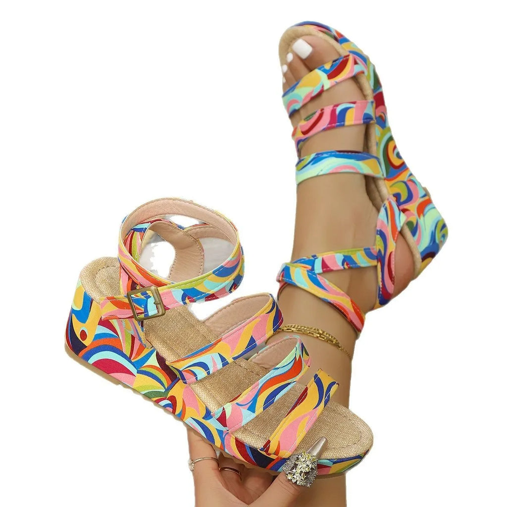 Women's light brown buckle wedge sandals with fish mouth toe and rubber sole on a white background.