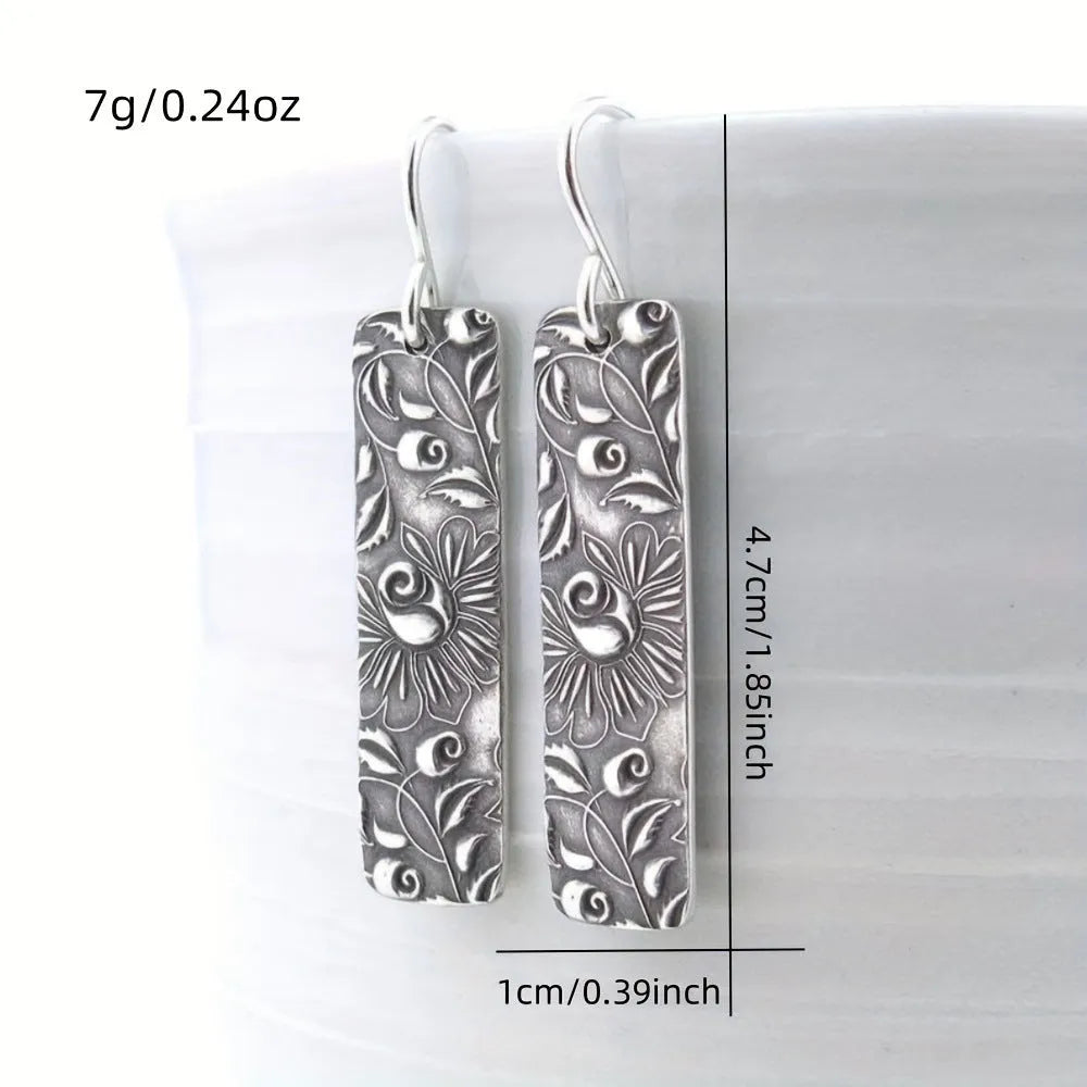 Silver geometric long earrings with carved vine detailing measuring 20 cm