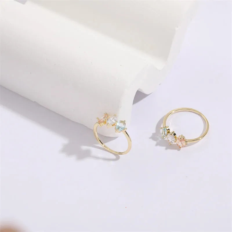 Geometric horse eye ring with tricolour zircon stones on a 14k gold-plated copper band.