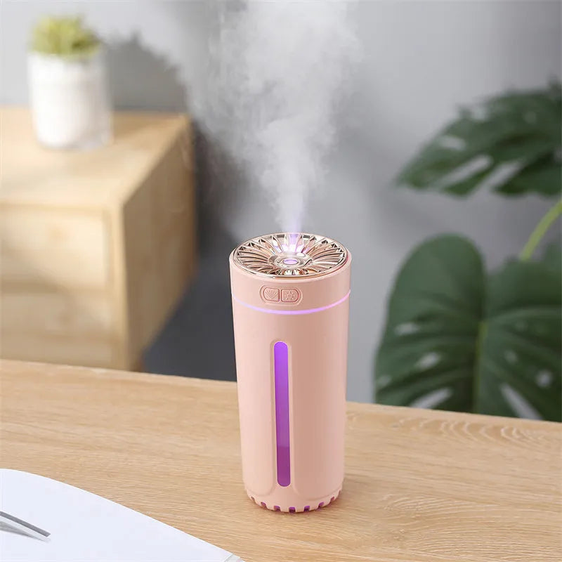 Black portable USB rechargeable humidifier with colourful LED lights on a car cup holder.