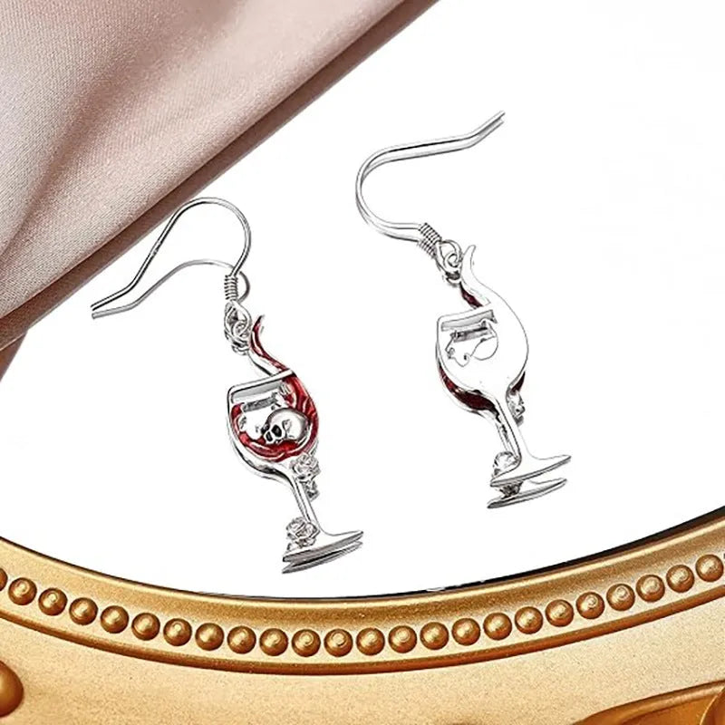 Close-up of zinc alloy Halloween earrings featuring a combined skull and wine glass design with an electroplated metallic finish.