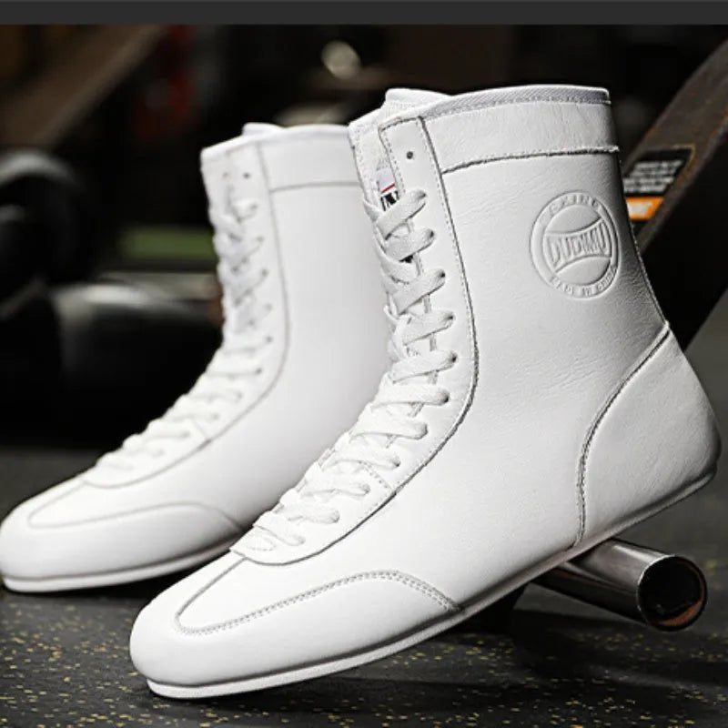 Professional black and gold mesh boxing shoes with leather upper and rubber sole.