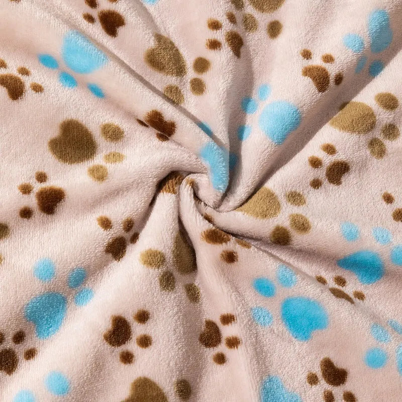 Double-sided dog blanket with cartoon patterns in blue dog, khaki paw, and blue paw designs on polyester flannel