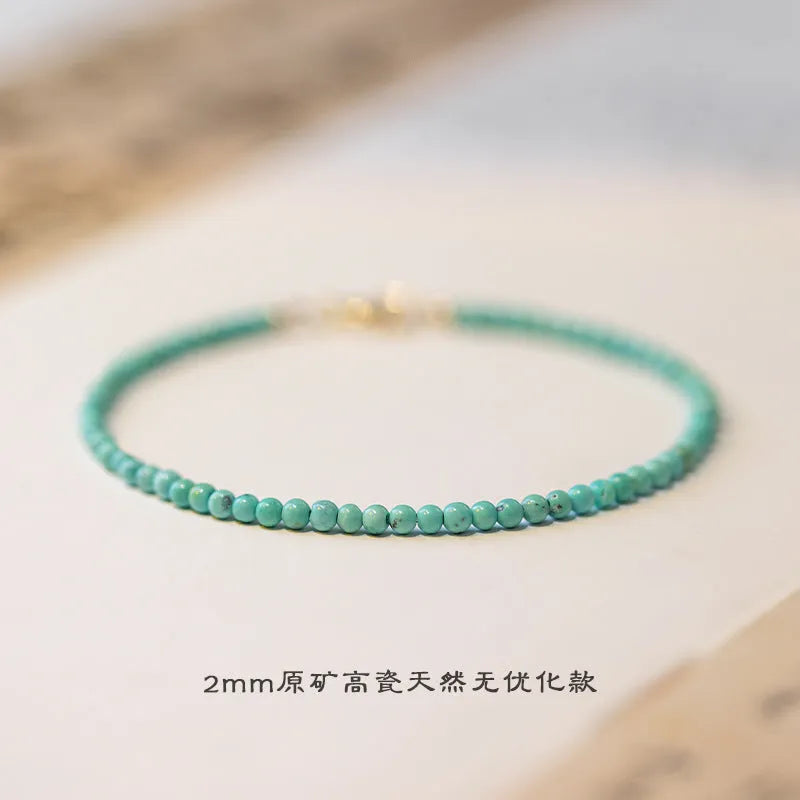 Natural 2mm raw ore turquoise bracelet on wrist, showing geometric beads and adjustable extension chain.