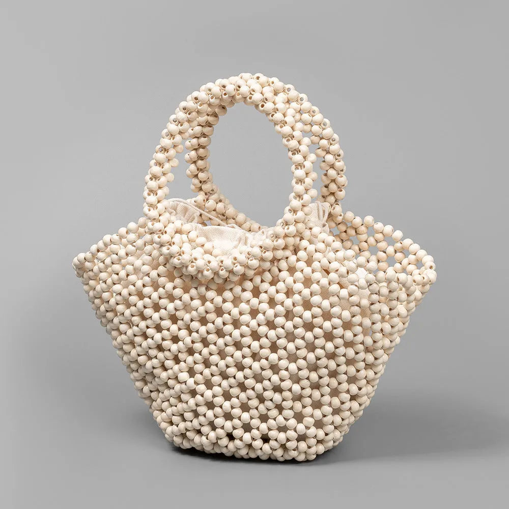 Hand-woven maple wood beach bag with wooden beads in dumpling shape.