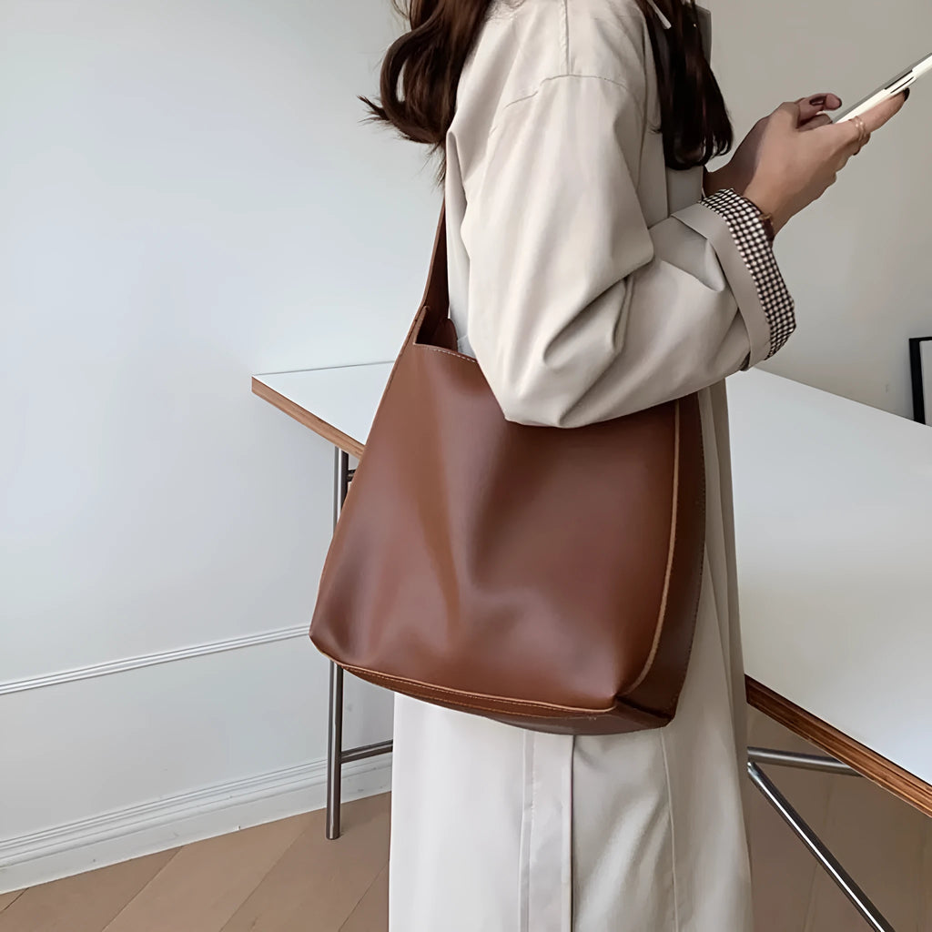 Two soft PU women's shoulder bags with swing threads decoration, shown in black and brown colour options.