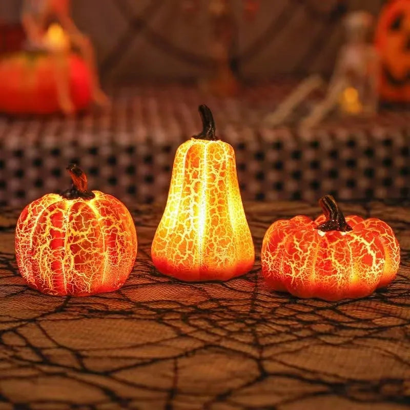 Set of three resin Halloween pumpkin lanterns with LED candle lights in short, medium, and long sizes.