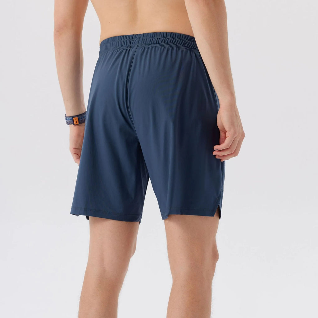 Man wearing black ice silk sports shorts, showing mid-waist fit and shorts length.